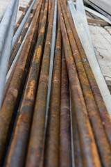rusty metal pipes for construction and industrial use laying on heap