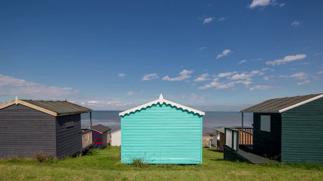 Time lapse of traditional english beach huts in whistable, kent, england on a summer's day
