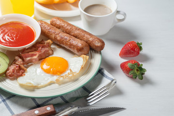 Nutritious breakfast, strawberry, bread, coffee orange juice, sausage, egg