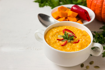 Vegetarian pumpkin soup in a bowl on the table.