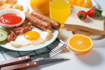 Nutritious breakfast, strawberry, bread, coffee orange juice, sausage, egg