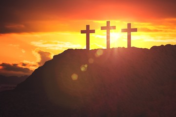 Silhouettes of three crosses at sunset on hill. Religion and christianity concept.