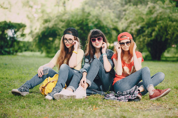 Naklejka na ściany i meble three young girls walking in the park