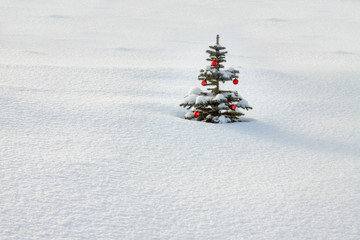 winter landscape with Christmas and new year fir tree decoration red ball and snow