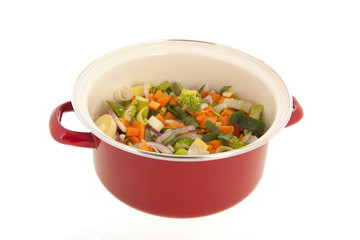 Mixed vegetables in red cooking pan