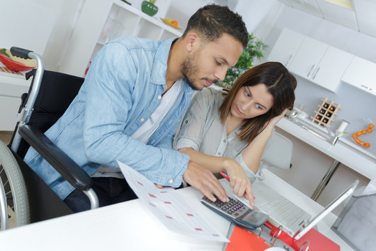 young attractive couple accounting at home