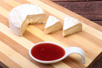 Cheese with white mold. Camembert or brie type with Cranberry sauce.. Healthy breakfast.