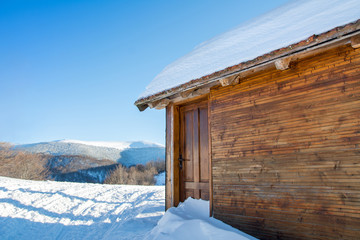 log cabin covered with snow