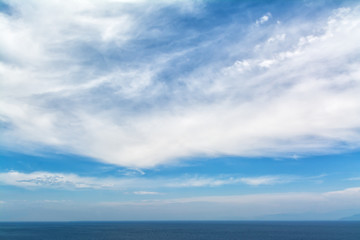 Fototapeta na wymiar blue sea horizon and white clouds backround