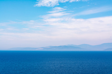 blue sea horizon and white clouds backround