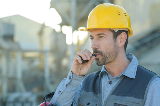 portrait of engineer smoking electronic cigarette outdoors