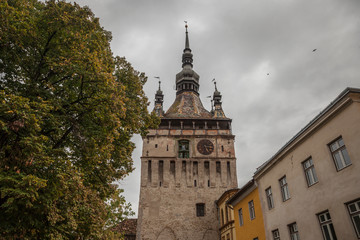 Sighisoara Clock Tower (Turnul cu Ceas) during a cloudy fall afternoon. It is the main entrance of Sighisoara castle, in Romania, birthplace of Vlad Tepes, aka Dracula.