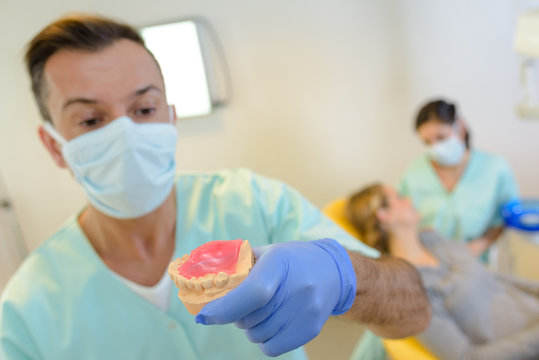 Dentist holding impressions