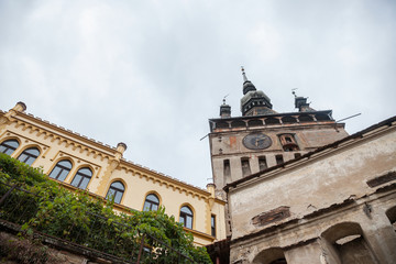 Fototapeta premium Sighisoara Clock Tower (Turnul cu Ceas) during a cloudy fall afternoon. It is the main entrance of Sighisoara castle, in Romania, birthplace of Vlad Tepes, aka Dracula.
