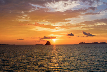 Beautiful natural landscape of colorful cloud sky and sun at sunset over the sea in Surat Thani province, Thailand
