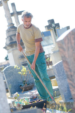 man cleaning a cementery