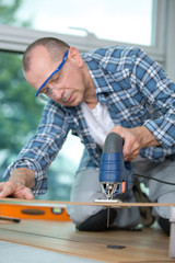 Man sawing through wooden board