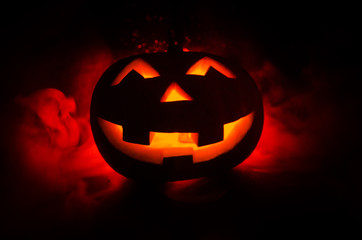 Halloween - old jack-o-lantern on black background. Closeup of scary halloween pumpkins