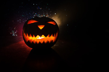 Halloween - old jack-o-lantern on black background. Closeup of scary halloween pumpkins