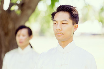 Handsome man practicing thai chi