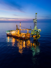 Aerial View of Tender Drilling Oil Rig (Barge Oil Rig) in The Middle of The Ocean at Sunrise Time