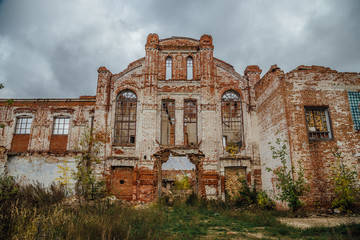 Ruined facade of red brick industrial building in art nouveau style. Abandoned and destroyed sugar factory in Novopokrovka, Tambov region