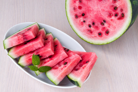 Ripe watermelon slices in a plate is on the table