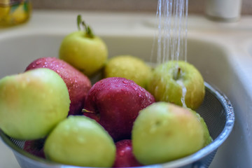 rinsing fresh picked apples in kitchen sink