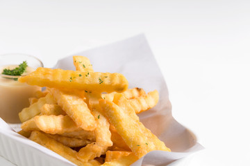 French fries in a bowl on a plate background.