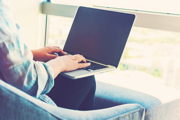 Woman on a laptop in a modern brightly lit room