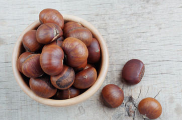Chestnuts roasted on wooden floor.