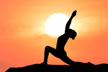 Fotobehang Silhouette of a beautiful Yoga woman with sun background © ittipol