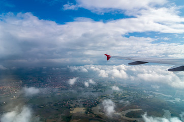 Clouds and sky over the country side as seen through window of an aircraft
