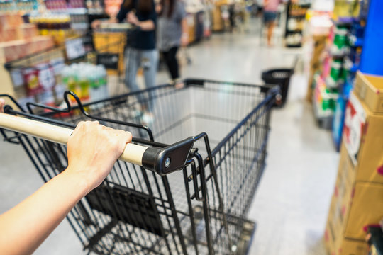 Woman pushing a shopping cart in supermarket