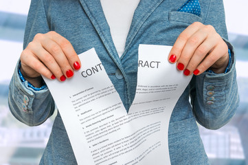 Business woman tearing contract in office