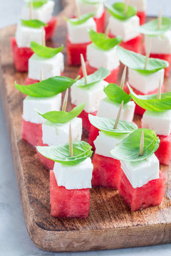 Watermelon Salad Or Caprese With Watermelon, Feta And Basil On Wooden Board, Vertical