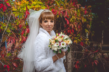 Young beautiful bride among thickets of wild grapes