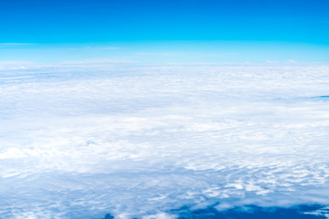 Fototapeta na wymiar Blue sky and Cloud Top view from airplane window,Nature background.