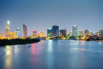 Night view of Business and Administrative Center of Ho Chi Minh city on Saigon riverbank in twilight, Vietnam.
