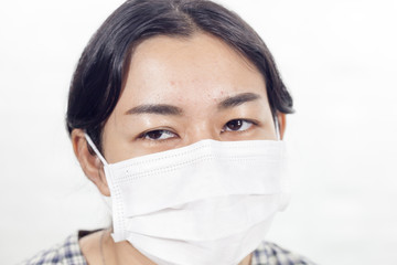 Close up young attractive asian woman who wore a mask