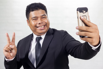  Fat businessman in a suit taking selfie