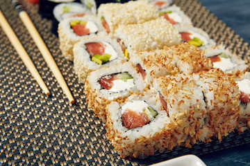 Menu of Japanese sushi rolls on black background