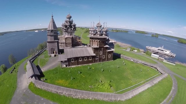 Aerial helicopter unique flight close to Ancient 22-dome Transfiguration wooden Church Kizhi Island. Beautiful Lake Onega Republic of Karelia Russia. Summer daylight.