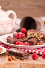 Obraz na płótnie Canvas Chocolate rolls with hazelnuts and raspberries.