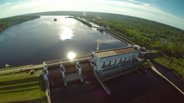 Flight around giant Russian hydroelectric power station industrial scenery . Volga river dam. Summer day sun reflections in water. Aerial drone helicopter footage