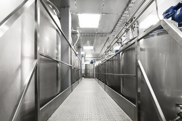 A long gangway between two rows of cisterns. Storage of food liquids.
