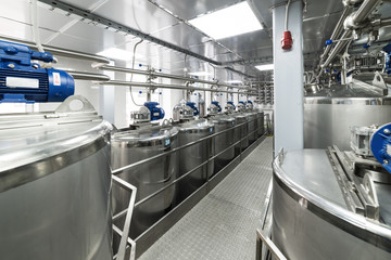 A lot of stainless steel tanks, modern production of spirits.