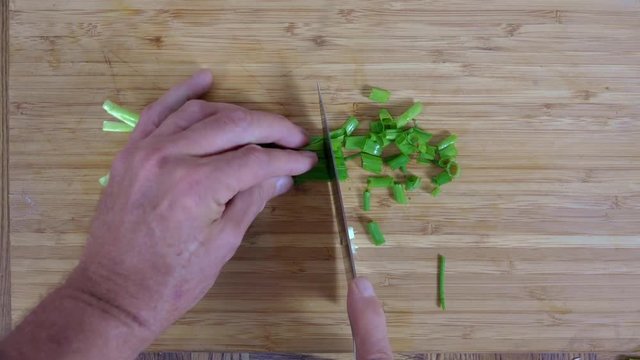 Overhead view of dicing green onions