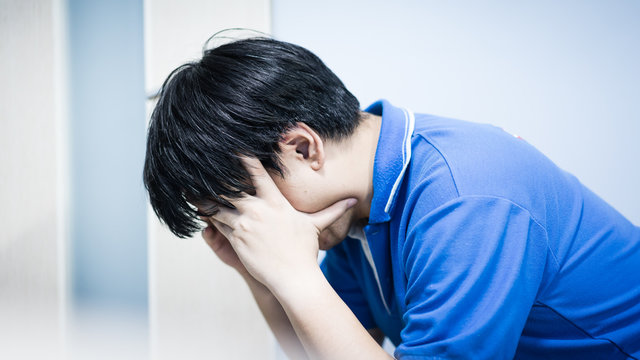 Asian Businessman in depression with hands on forehead, Image of Stressed businessman concept.