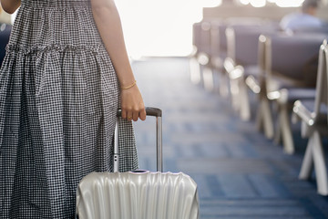 close up woman hand touching baggage for check in at counter in airport,traveling in vacation...